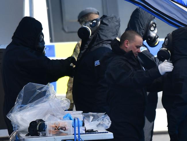 Police don protective coveralls with breathing equipment as they carry out investigations after the nerve agent attack.