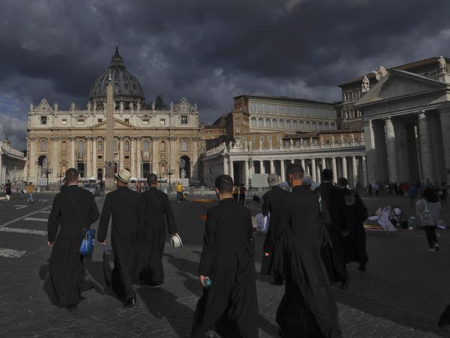 Priests walk in St. Peter's Square, at the Vatican. Picture: AP Photo/Gregorio Borgia