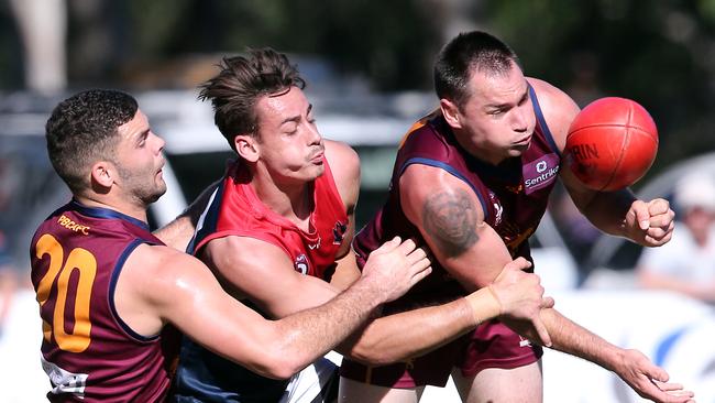 esse Derrick hand balls under pressure. Gold Coast 11th May, 2019 AAP Image/Richard Gosling