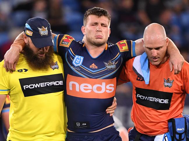 Jai Arrow of the Titans is taken from the field injured during the Round 14 NRL match between the Gold Coast Titans and the New Zealand Warriors at CBus Super Stadium on the Gold Coast, Friday, June 14, 2019.  (AAP Image/Dave Hunt) NO ARCHIVING, EDITORIAL USE ONLY