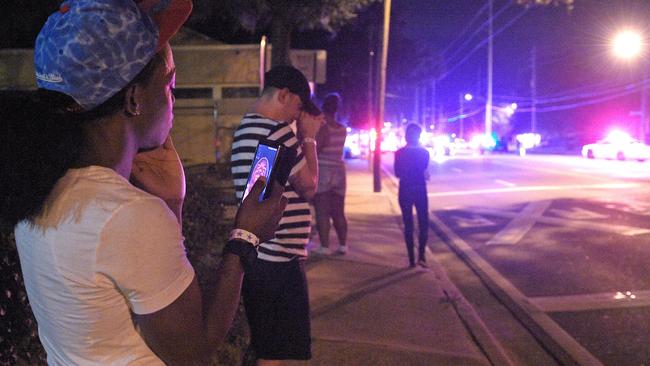 Onlookers wait down the street from the scene of a shooting involving multiple fatalities at a nightclub in Orlando, Florida. Picture: Phelan M Ebenhack