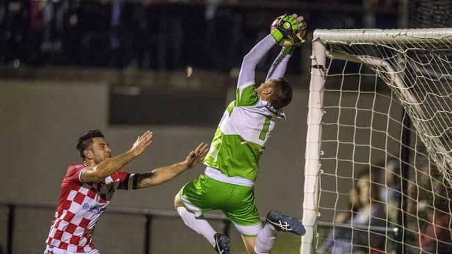 Gold Coast Premier League grand final between Broadbeach United and Gold Coast Knights at Croatian Sports Centre on Saturday. Gold Coast Knights' Andrew Barisic and Broadbeach United's goal keeper Michael Negrepontis . Picture: Jerad Williams