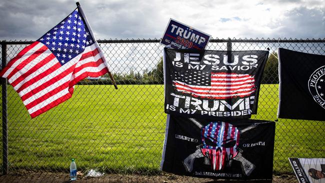 Flags are draped along a fence at a Proud Boys rally at Delta Park in Portland, Oregon on September 26. Picture: AFP