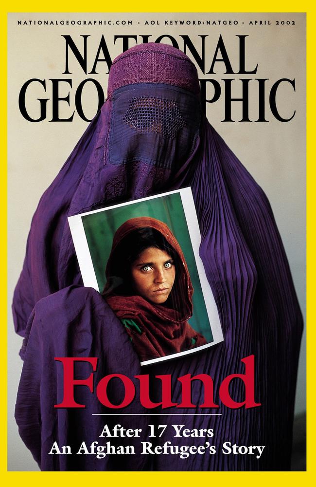 Sharbat Gula holds her portrait, which became the most famous picture ever to appear on the cover of National Geographic magazine. Picture: AP Photo/National Geographic Society, Steve McCurry