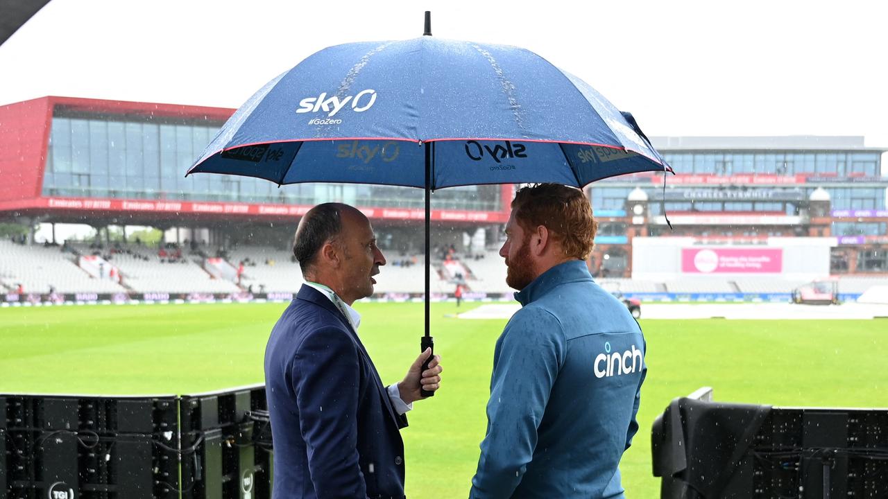 England's Jonny Bairstow (R) chats with former England captain Nasser Hussain (L) as rain delays play on day four of the fourth Ashes Test. (Photo by Oli SCARFF / AFP)