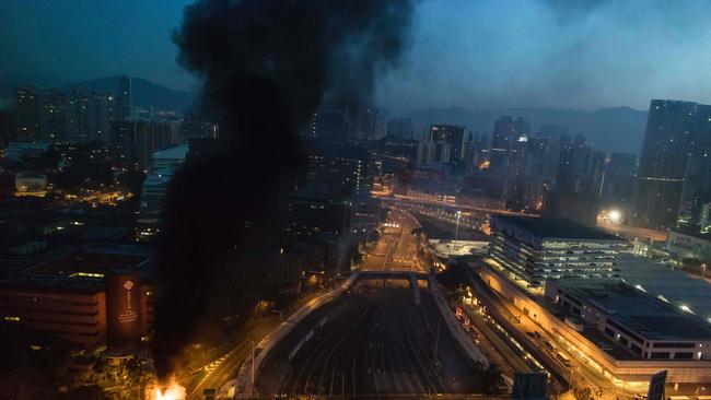 Smoke billows from a fire next to Hong Kong Polytechnic University and the road leading to the Cross Harbour Tunnel. Picture: Dale de la Rey/AFP