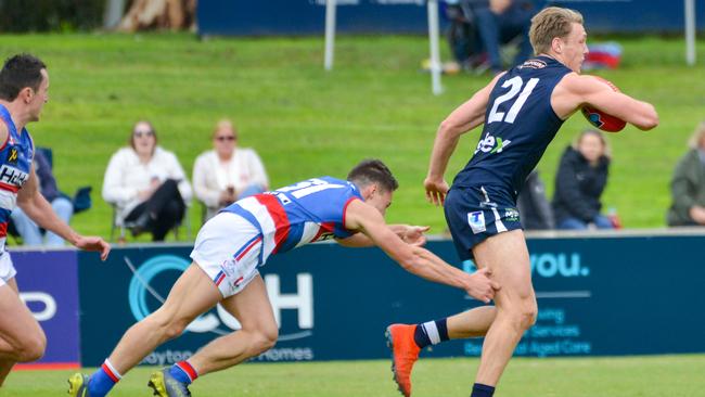 Central District youngster Corey Durdin attempts to tackle South’s Ben Heaslip last season. Picture: AAP/Brenton Edwards