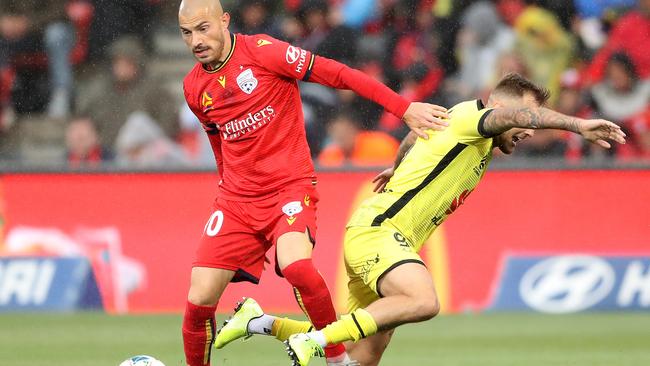 James Troisi fends off David Ball during Adelaide United’s home loss to Wellington Phoenix. Picture: Robert Cianflone/Getty Images