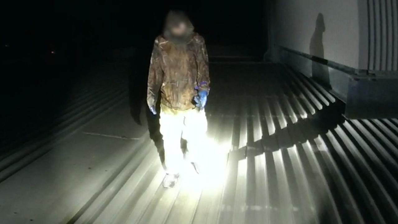 A frame grab from a video supplied by Townsville Police showing a copper thief caught red-handed atop Woodlands Village Shopping Centre on Palm Drive in Deeragun on Sunday night. Picture: Supplied