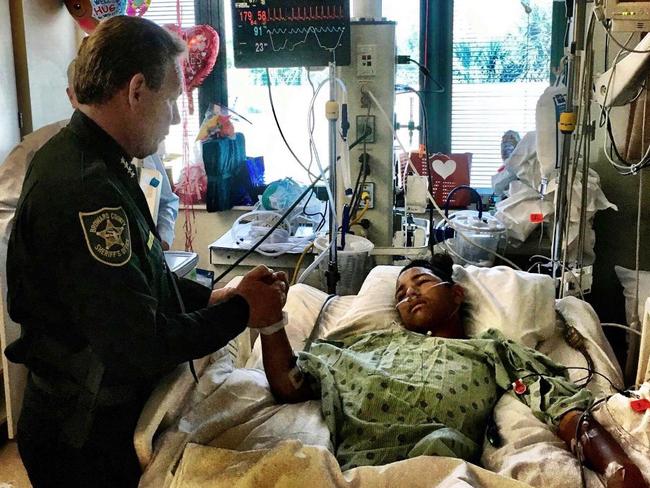 Sheriff Scott Israel holds the hand of Anthony Borges, 15, a student at Marjory Stoneman Douglas High School credited with saving the lives of at least 20 other students. Picture: (Broward County Sheriff's Office