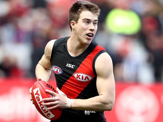 MELBOURNE, AUSTRALIA - AUGUST 05: Zach Merrett of the Bombers runs with the ball during the round 20 AFL match between the Essendon Bombers and the Carlton Blues at Melbourne Cricket Ground on August 5, 2017 in Melbourne, Australia.  (Photo by Robert Cianflone/Getty Images)