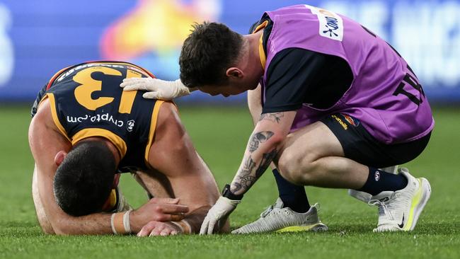 Taylor Walker of the Crows in pain after being hit high by Tim English of the Bulldogs during the round 22. Picture: Mark Brake/