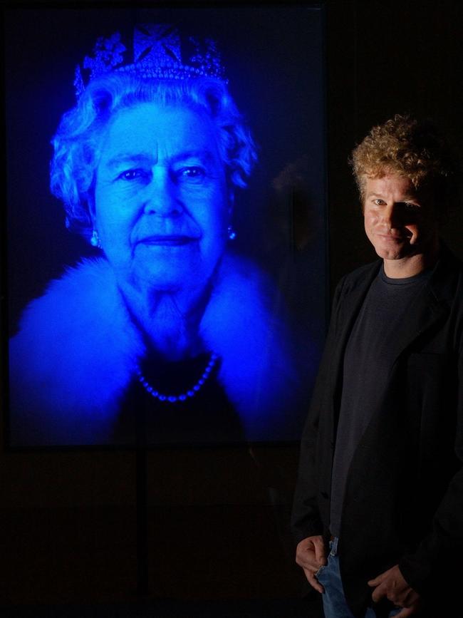 Chris Levine with his work, Lightness of Being, the first holographic portrait of Queen Elizabeth, in 2004. Picture: AP Photo/Fiona Hanson/PA