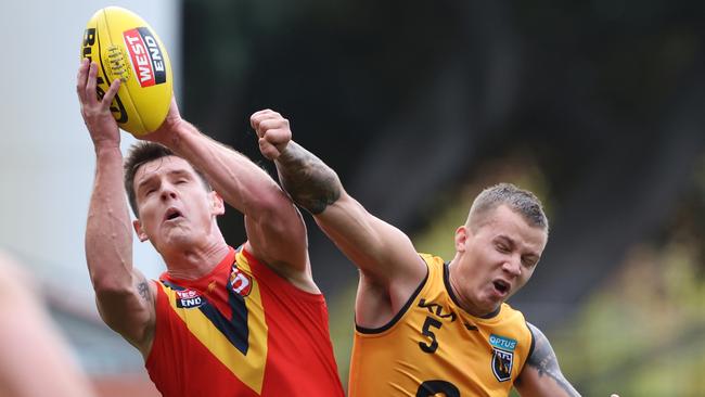 Luke Thompson from South Australia marks the ball ahead of Cody Ninyette from Western Australia during the state match between SANFL and WAFL at Adelaide Oval in Adelaide, Saturday, May 15, 2021. (SANFL Image/David Mariuz)