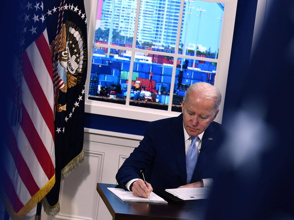 US President Joe Biden takes notes during a meeting. A former US task force chief has said the pandemic should turn endemic this year. Picture: Brendan Smialowski / AFP