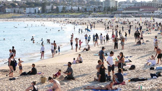 People out at Bondi Beach just as the police arrived to do Covid compliance checks. Picture: Damian Shaw