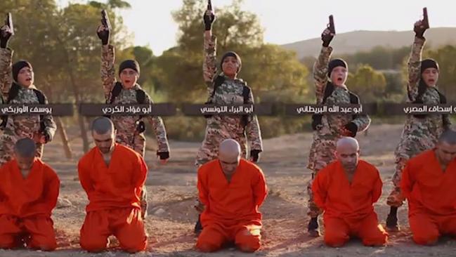 The kids, wielding pistols and dressed as IS fighters, are shown executing IS captives in Raqqah.