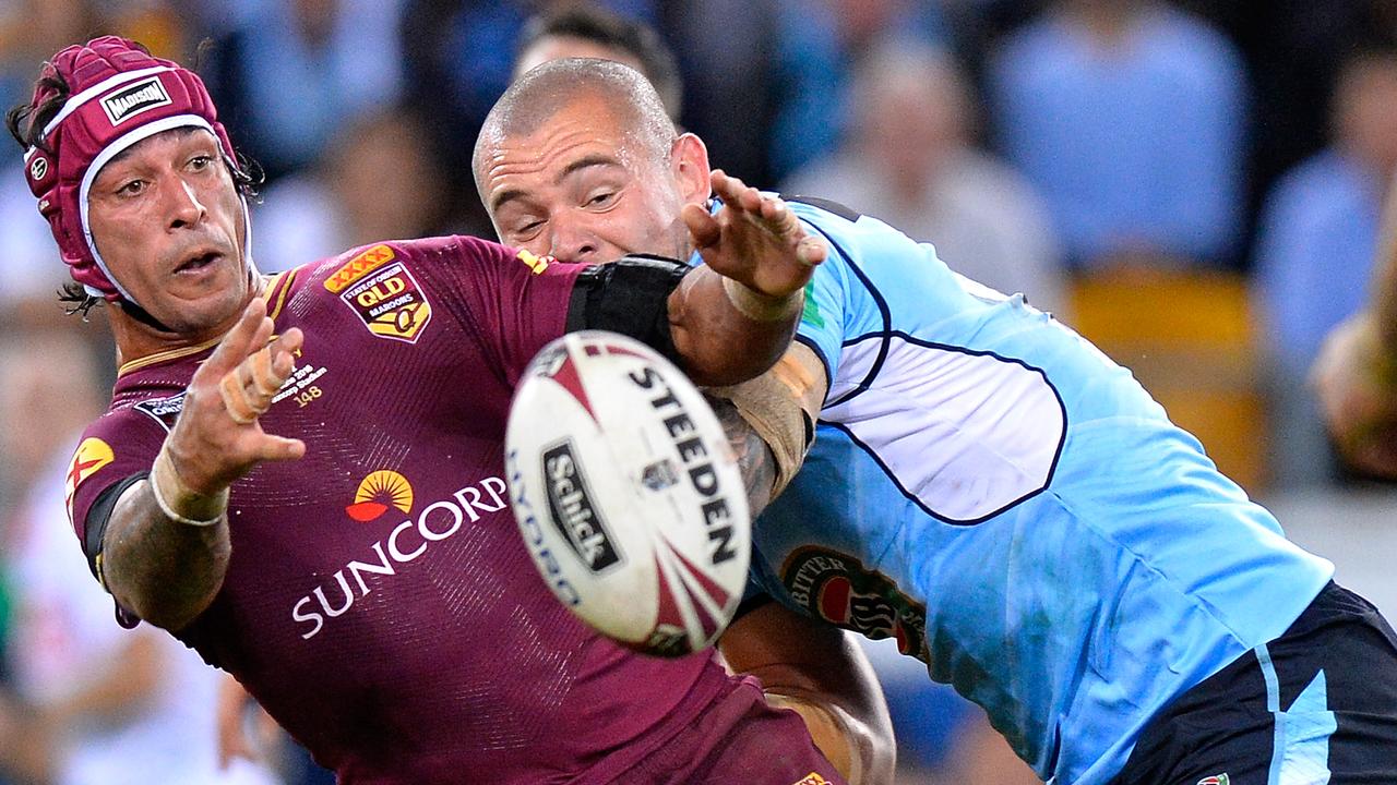Johnathan Thurston of the Maroons offloads during game two of 2016.