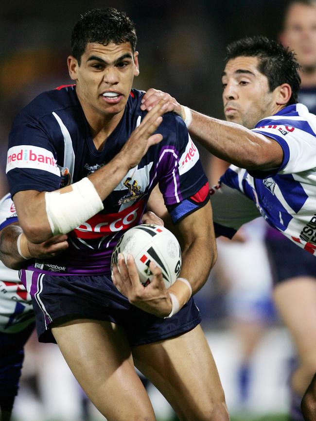 Inglis brushes aside Braith Anasta during a Melbourne Storm vs Canterbury Bulldogs match. 