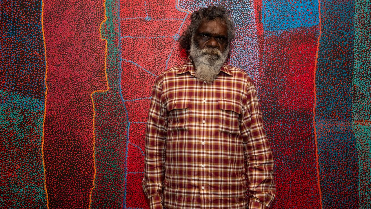 Telstra National Aboriginal and Torres Strait Islander Art Awards winner Noli Rictor, a Pitjantjatjara man, standing next to his artwork Kamanti which depicts his own Spinifex country at the Museum and Art Gallery of the Northern Territory (MAGNT), on Larrakia Country, Darwin. Picture: Pema Tamang Pakhrin