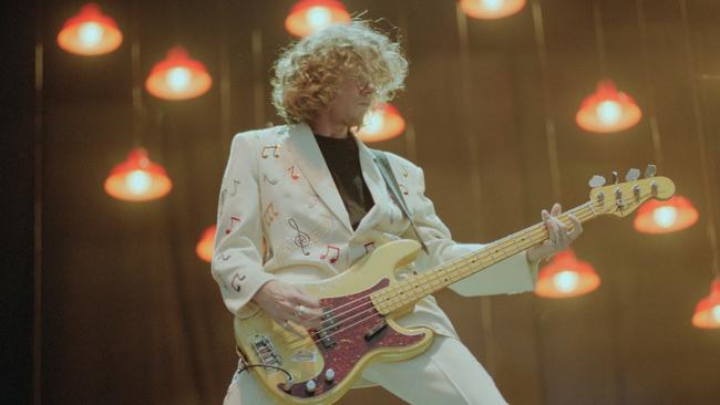 Bass guitarist Mike Mills performs on stage at Milton Keynes Bowl in England in 1995. Picture: Brian Rasic/Getty