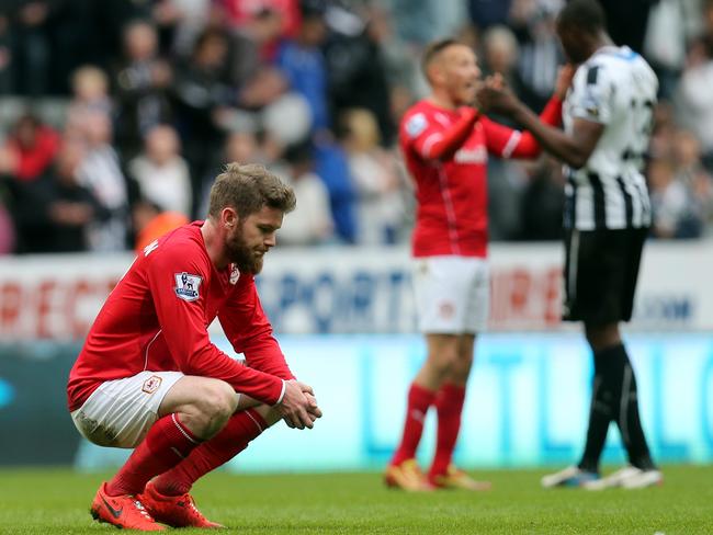 Cardiff City's Aron Gunnarsson sits dejected after being defeated by Newcastle United.