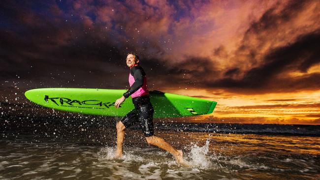 Boardrider Quentin Poulsen at sunrise - the sun will continue to rise around 6.30am for the next month. Picture Lachie Millard