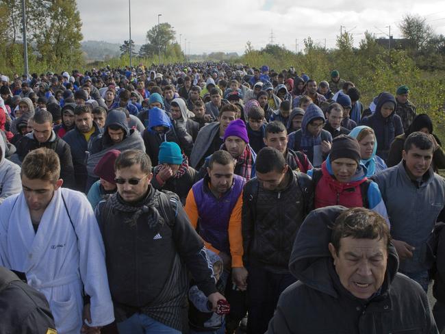 Migrants walk towards a reception facility after crossing from Croatia, in Dobova, near a border crossing between Croatia and Slovenia Tuesday, Oct. 20, 2015. Slovenia accused Croatia on Tuesday of sending thousands of migrants toward its borders 