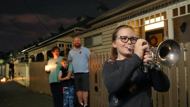 8 year old Audrey Taylor plays the Last Post in front of her home in Richmond. Picture: David Crosling