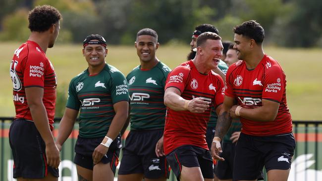 Rabbitohs players watch on as Jack Wighton and Latrell Mitchell share a laugh at training on Monday. Picture: Jonathan Ng