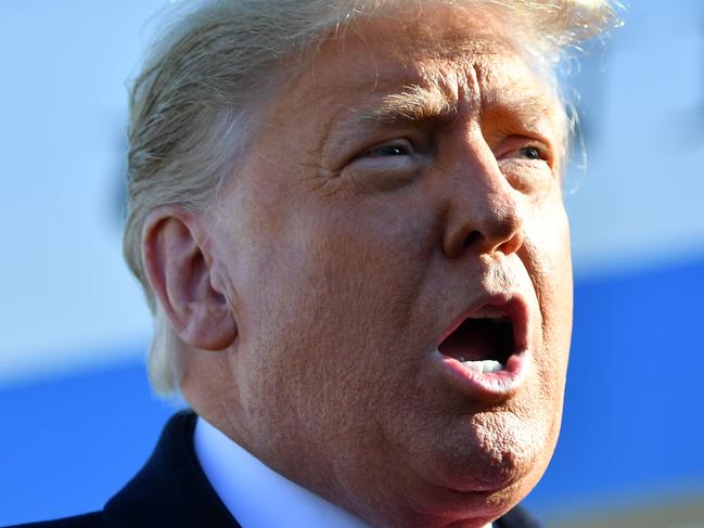 US President Donald Trump speaks to the media as he makes his way to board Air Force One before departing from Andrews Air Force Base in Maryland on January 12, 2021. - Trump is traveling to Texas to review his border wall project. (Photo by MANDEL NGAN / AFP)