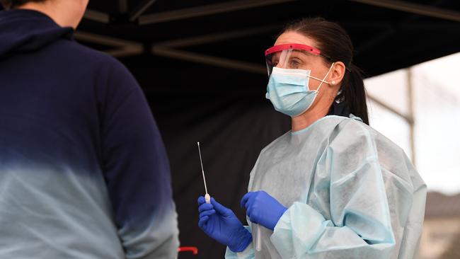 A healthcare worker conducts a COVID-19 test at a Coronavirus pop-up testing facility in Broadmeadows, Melbourne on Friday. Picture: James Ross/AAP