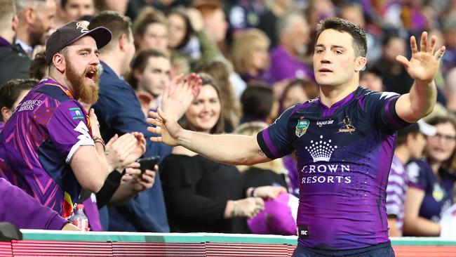 Cooper Cronk of the Storm waves goodbye to fans in the AAMI Park crowd.