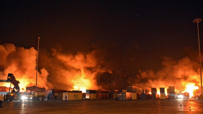 Firefighters battle a blaze at Syria's Latakia port after an Israeli air strike early yesterday. Picture: AFP.