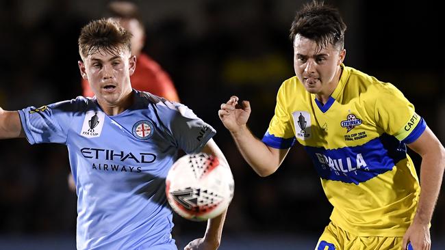 Connor Metcalfe of Melbourne City (left) and Jake McLean of the Strikers compete for the ball on Tuesday night. Picture: Getty Images