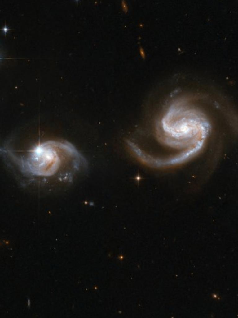 At 500,000 light-years, dark matter provides friction that brings galaxies to a close encounter. Photo by Handout / NASA/ESA / AFP