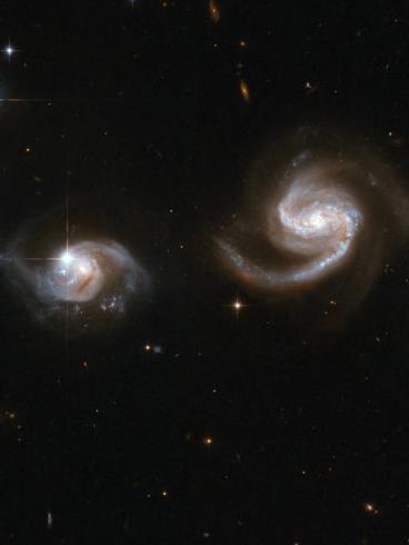 At 500,000 light-years, dark matter provides friction that brings galaxies to a close encounter. Photo by Handout / NASA/ESA / AFP
