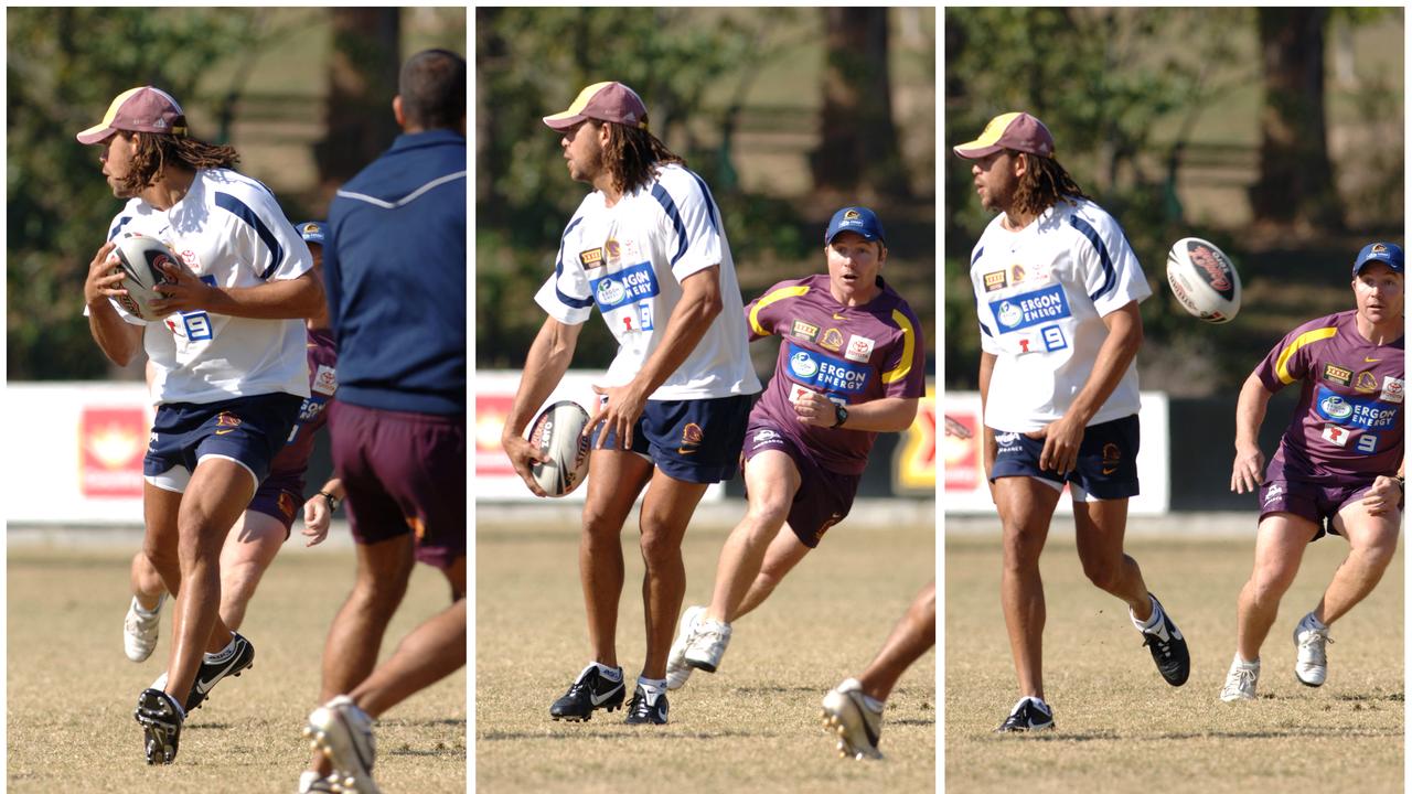 Andrew Symonds flick-passes the ball behind his back to Paul Green during the Broncos team training session in 2007. Picture: AAP Image/Dave Hunt