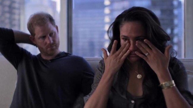 Meghan Markle wipes her eyes as a concerned Prince Harry looks on. Picture: Netflix