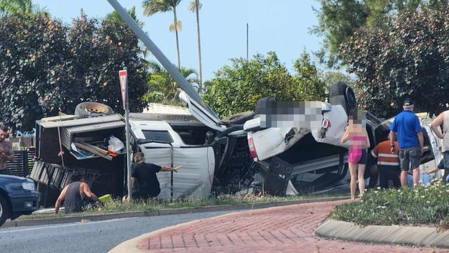 Emergency crews were called following a two-vehicle crash into a power pole at Paget that caused car to roll onto its roof.