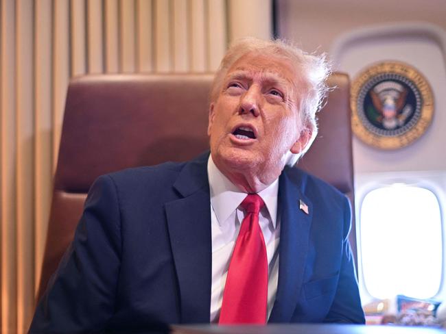 US President Donald Trump announces new tariffs on steel and aluminium while speaking to reporters on Air Force One. Picture: Roberto Schmidt (AFP)