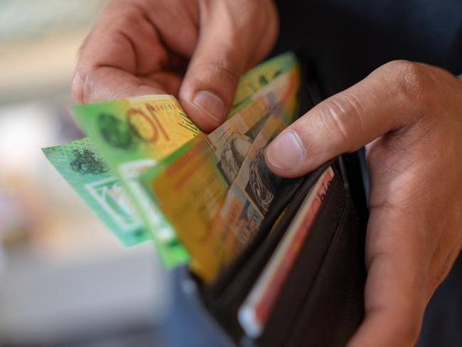 a male taking money out of the valet.