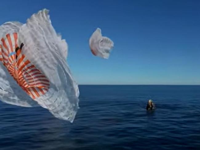 The SpaceX capsule makes splashdown off the coast of Florida.