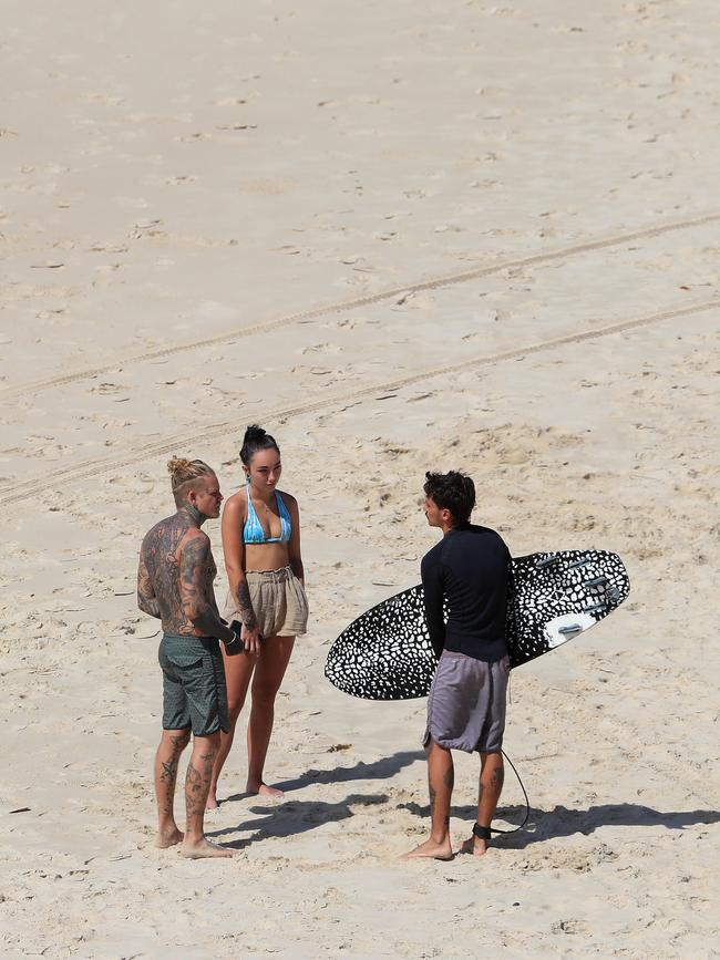 Beachgoers stop for a chat on the Gold Coast. Picture: Adam Head