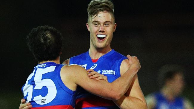 An elated Josh Schache celebrates his matchwinning with teammate Alex Greenwood on Saturday night. Picture: Getty Images