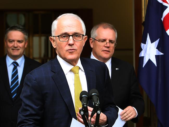 Mr Turnbull, pictured at a press conference with Mr Cormann and Mr Morrison yesterday, is trying to hold on to his position as Prime Minister. Picture Kym Smith