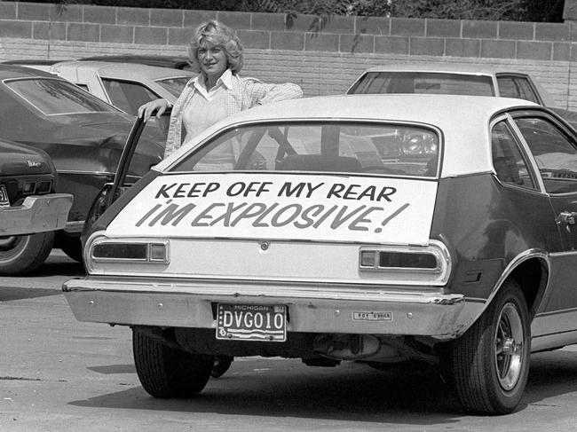 FILE - In this Sept. 1, 1978 file photo, Patty Ramge poses with her 1975 Ford Pinto that bears a sign warning fellow motorists to keep their distance, in Detroit. Ramge posted the warning after weeks of trying to convince Ford Motor Co., and its dealers to modify the Pinto's fuel tank so it would not pose a fire hazard in a rear-end crash. At least 27 people died during the 1970s due to the faulty position of fuel tanks in the Ford Pinto. (AP Photo/JCH, File)