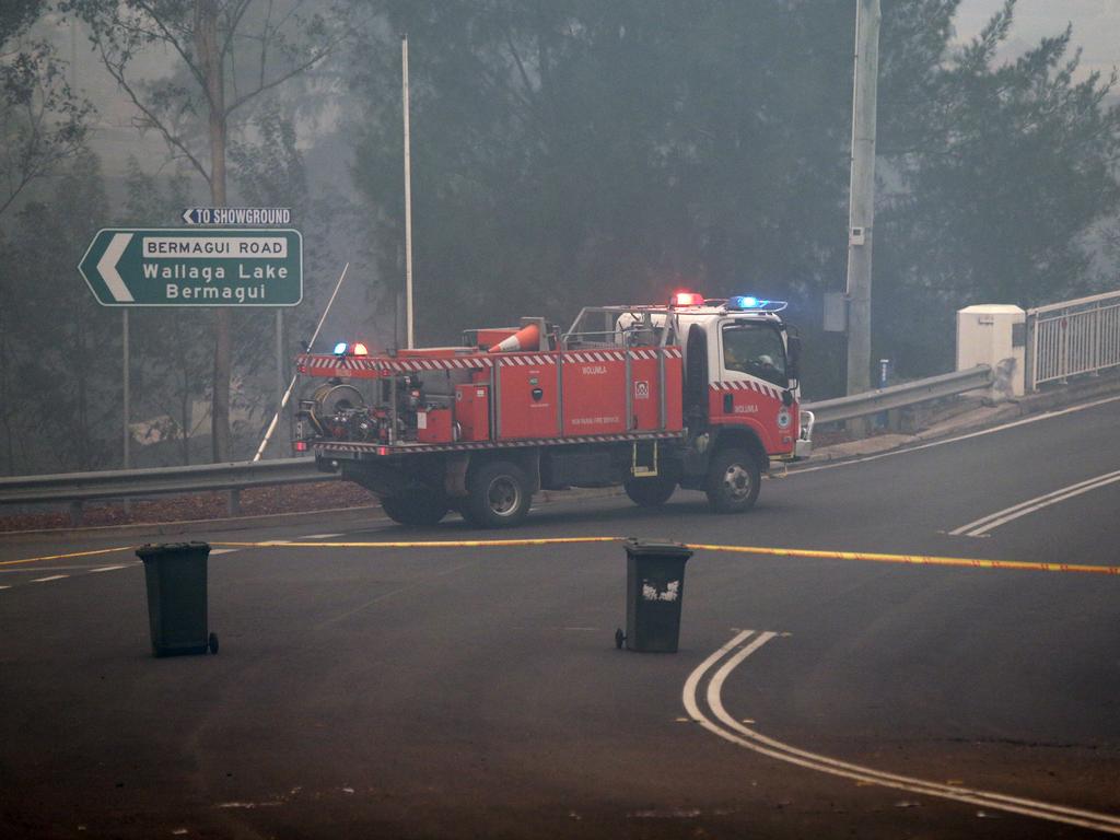 The morning after a devastating blaze destroyed homes and businesses in the small town of Cobargo. The town has been decimated by fire. RFS volunteers access the damage in the Main Street of Cobargo on New Years Day. Picture Gary Ramage