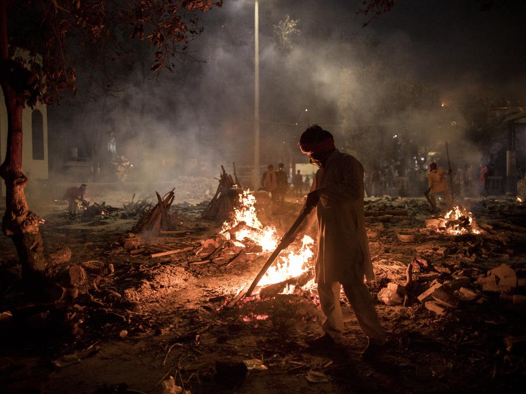 Workers at a crematorium where multiple funeral pyres are burning for patients who lost their lives to COVID-19. Picture; Anindito Mukherjee/Getty Images