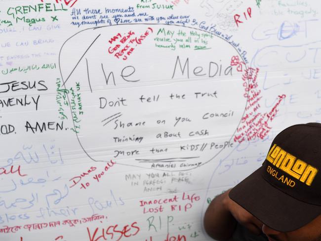 Messages and pictures of missing people are posted on a wall near the Grenfell Tower. Picture: AFP